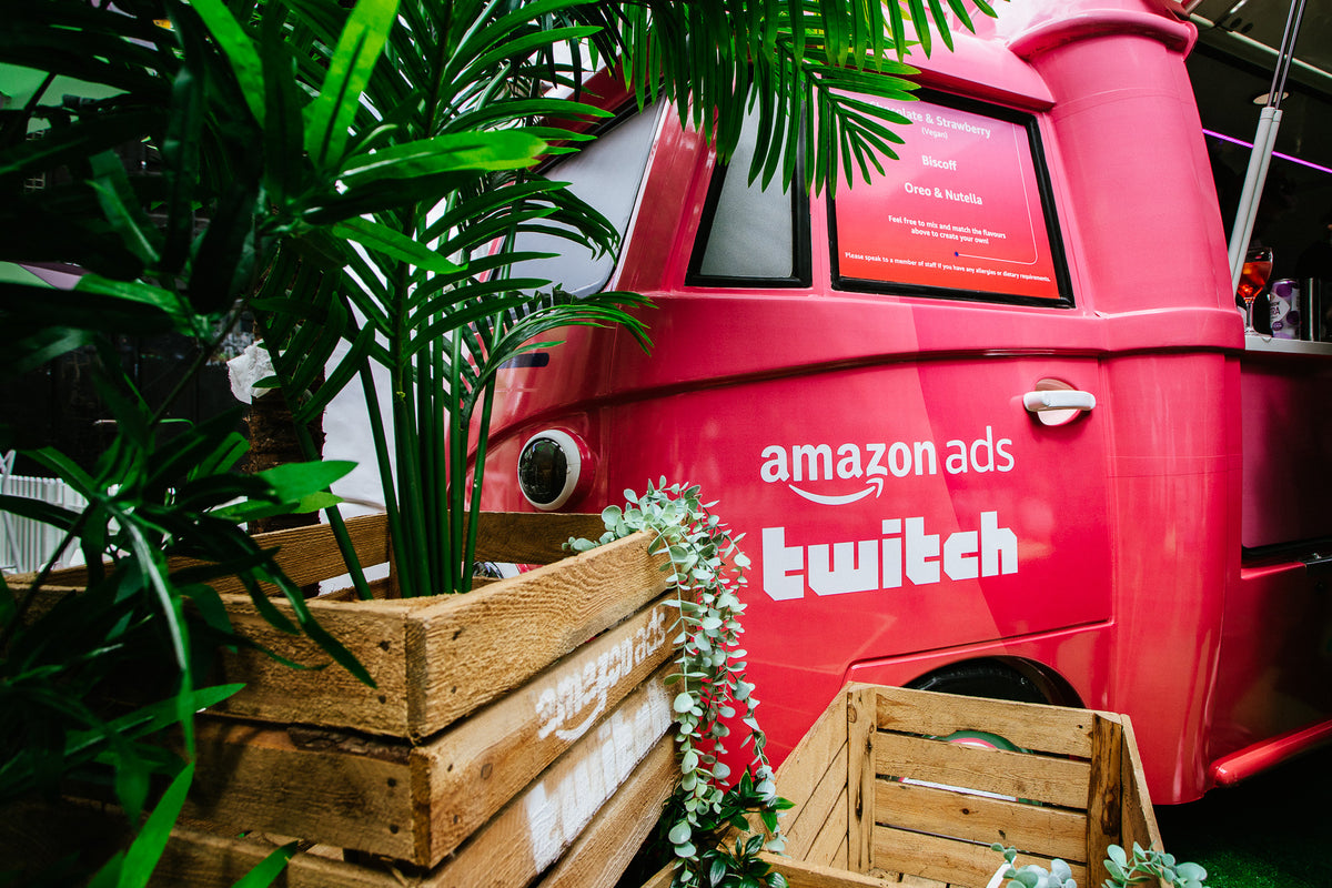 Pink Amazon Ads and Twitch-branded VW truck with matching event planters