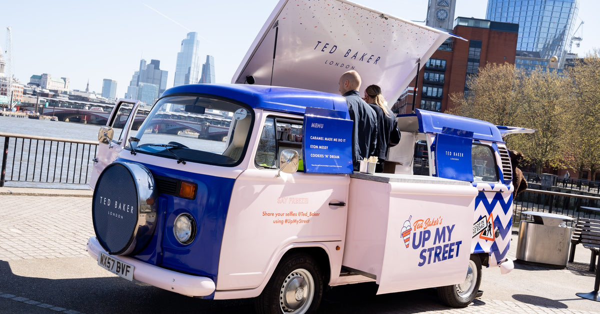 Blue and pink Ted Baker-branded Pan-n-Ice VW truck beside the River Thames