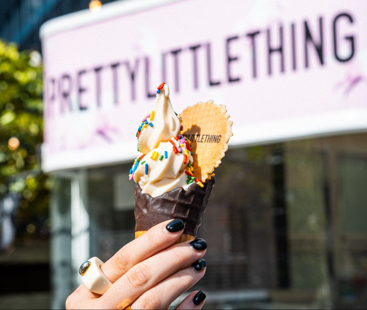 Soft serve ice cream with a branded wafer outside a PrettyLittleThing event; service example from a separate event
